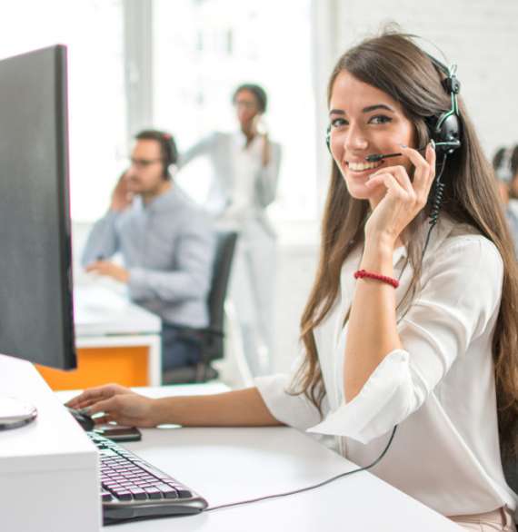 Young,Friendly,Operator,Woman,Agent,With,Headsets,Working,In,A